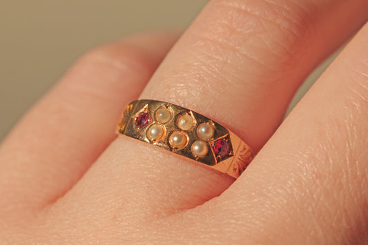Victorian 15 carat gold ring with diamond shaped ruby bezels on finger