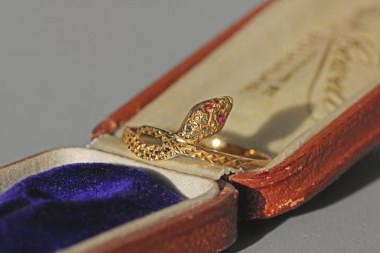 Vintage ouroboros snake ring with pink topaz eyes, in 9 carat gold