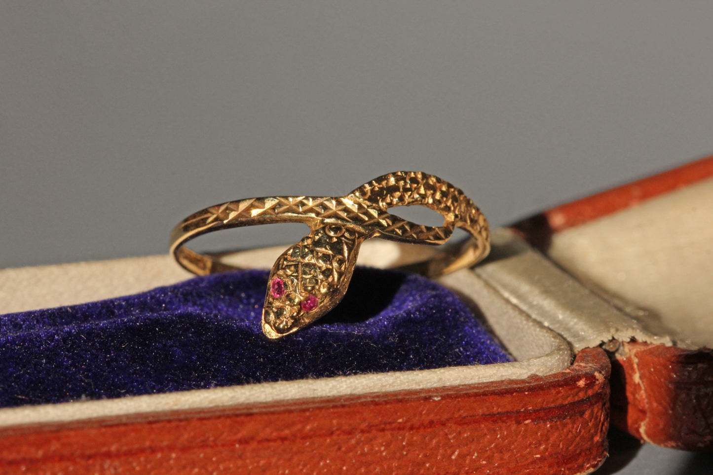 Vintage ouroboros snake ring with pink topaz eyes, in 9 carat gold