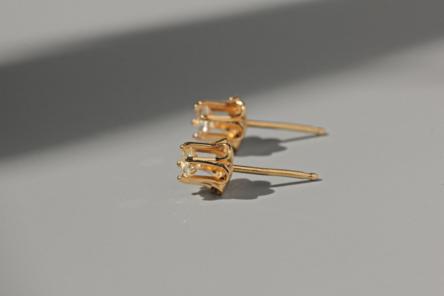 Vintage diamond solitaire buttercup belcher earrings, in 14 carat gold
