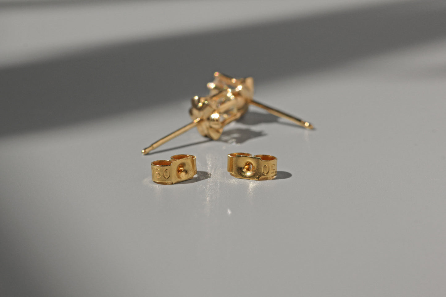 Vintage diamond solitaire buttercup belcher earrings, in 14 carat gold