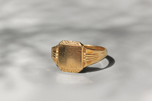 Close up of blank signet face with foliate scroll detail