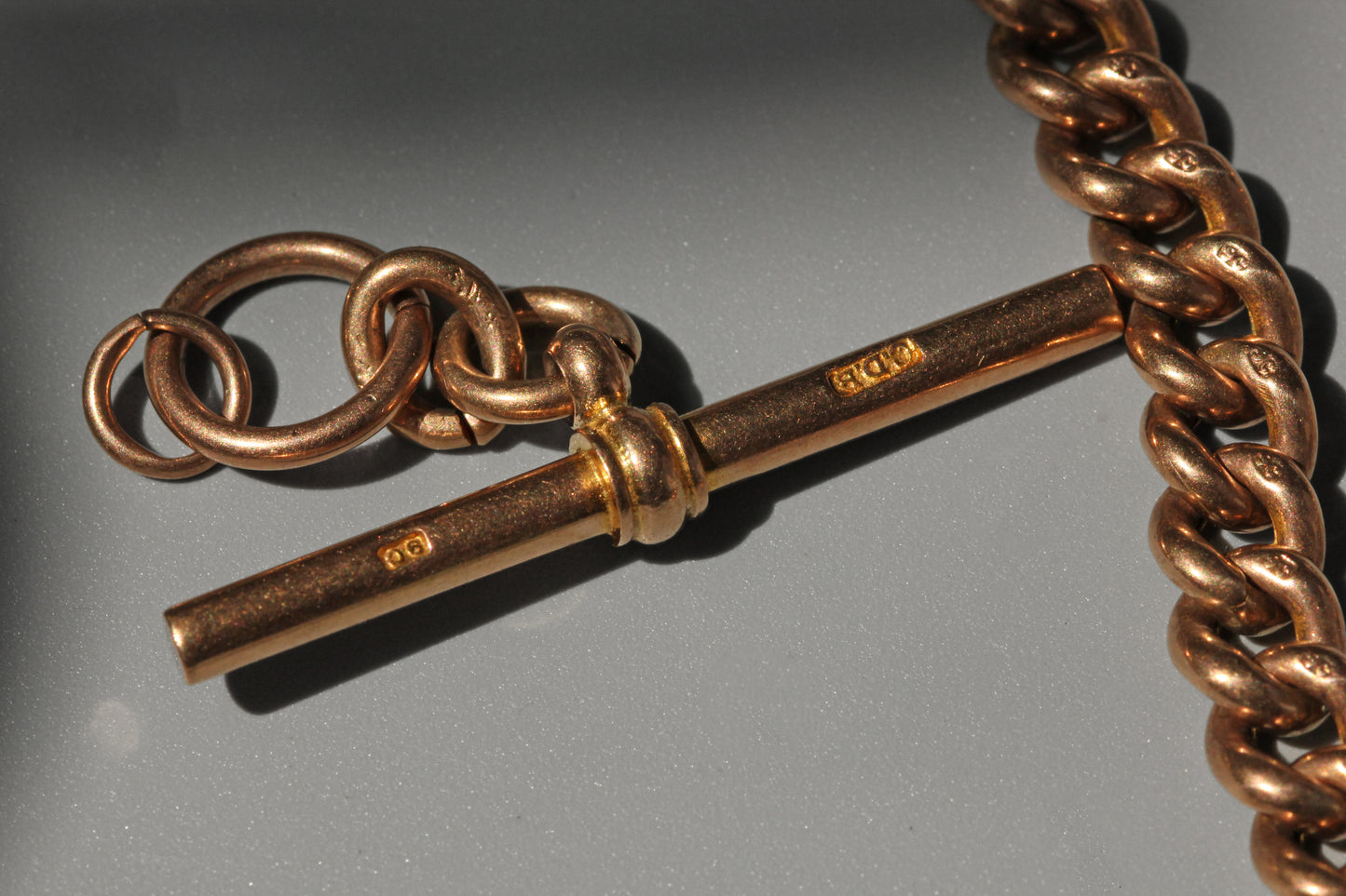 Antique curb link albert chain with tbar, in 9 carat gold