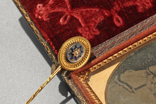 Front view of an antique Victorian pearl and blue enamel stick pin