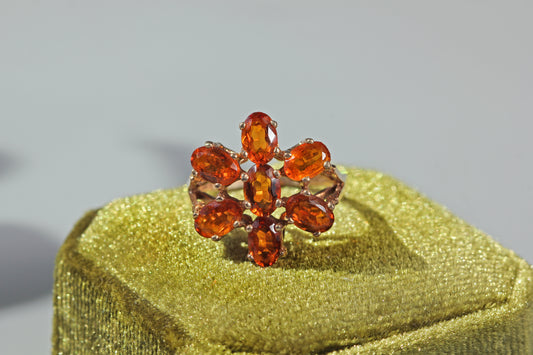 Vintage 9ct gold orange topaz flower cluster ring with seven oval cut stones in a bold floral design