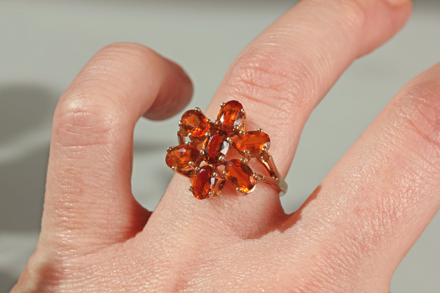 Bold 1970s floral cocktail ring with vivid orange topaz stones in warm amber tones