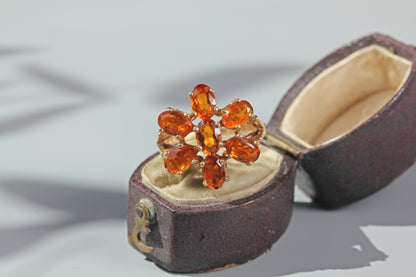 1970s orange topaz floral cluster ring in 9 carat gold displayed in an antique ring box
