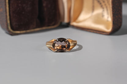 Vintage 1975 smoky quartz ring displayed in antique ring box
