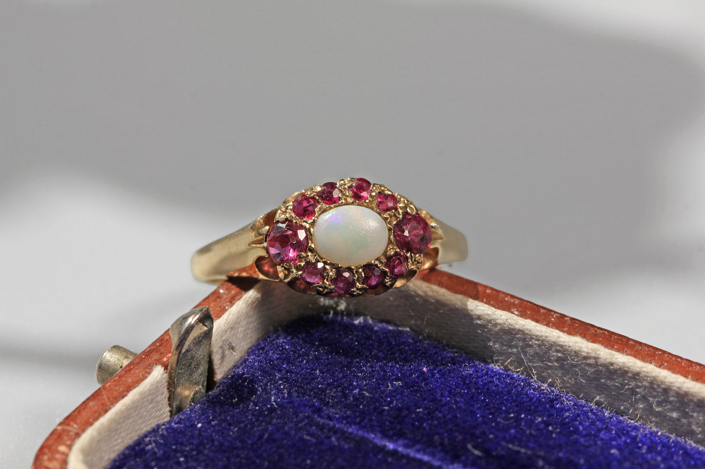 Front view of a vintage opal and ruby cluster ring in 9ct yellow gold