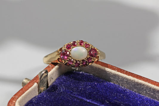 Front view of a vintage opal and ruby cluster ring in 9ct yellow gold