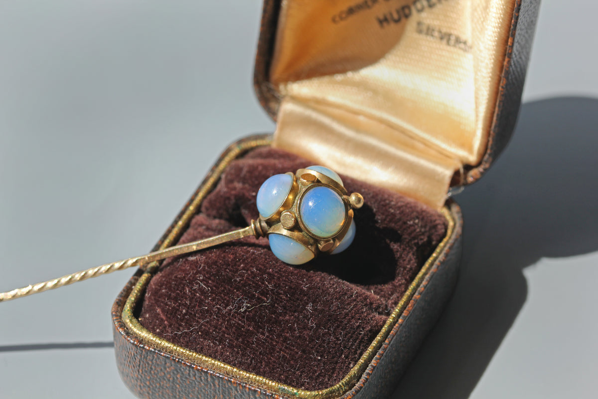 A victorian stick pin decorated with opals and gold studs, in 9ct gold photographed in antique ring box 