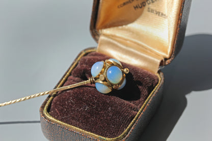 A victorian stick pin decorated with opals and gold studs, in 9ct gold photographed in antique ring box 