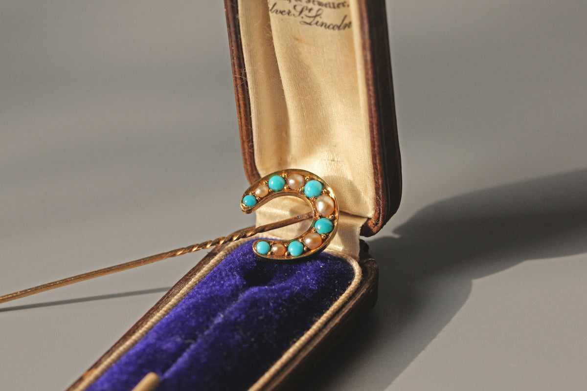 Antique Victorian pearl and turquoise lucky horseshoe pin in 18 carat gold in antique blue velvet jewellery box