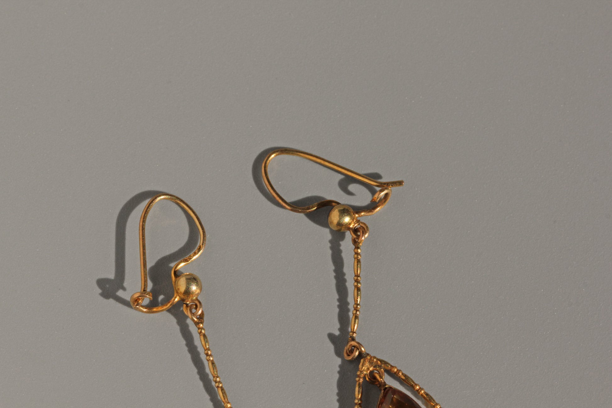 Antique 9ct gold earrings with suspended topaz and delicate frame