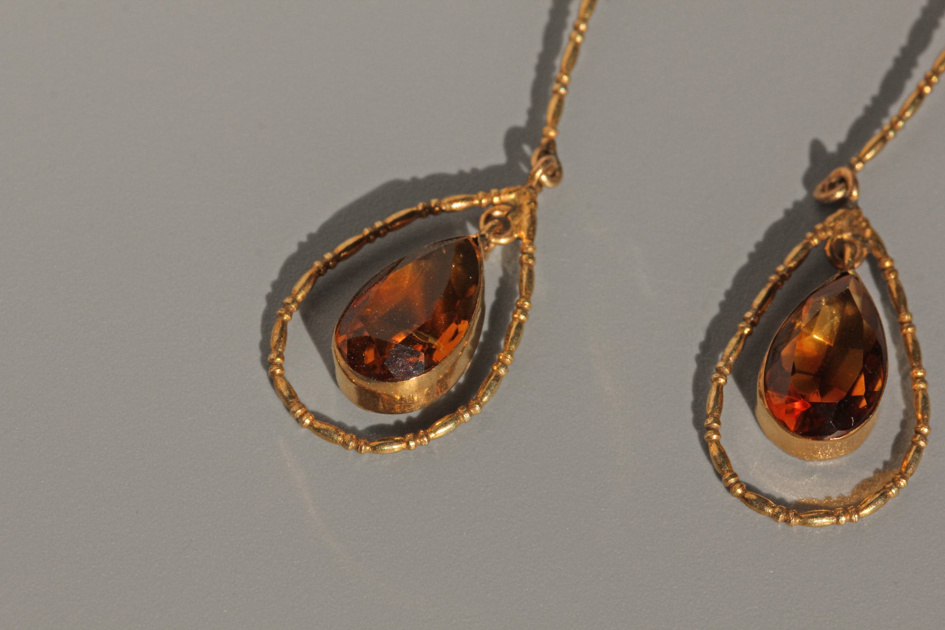 Detailed view of topaz gemstone in gold teardrop drop earrings