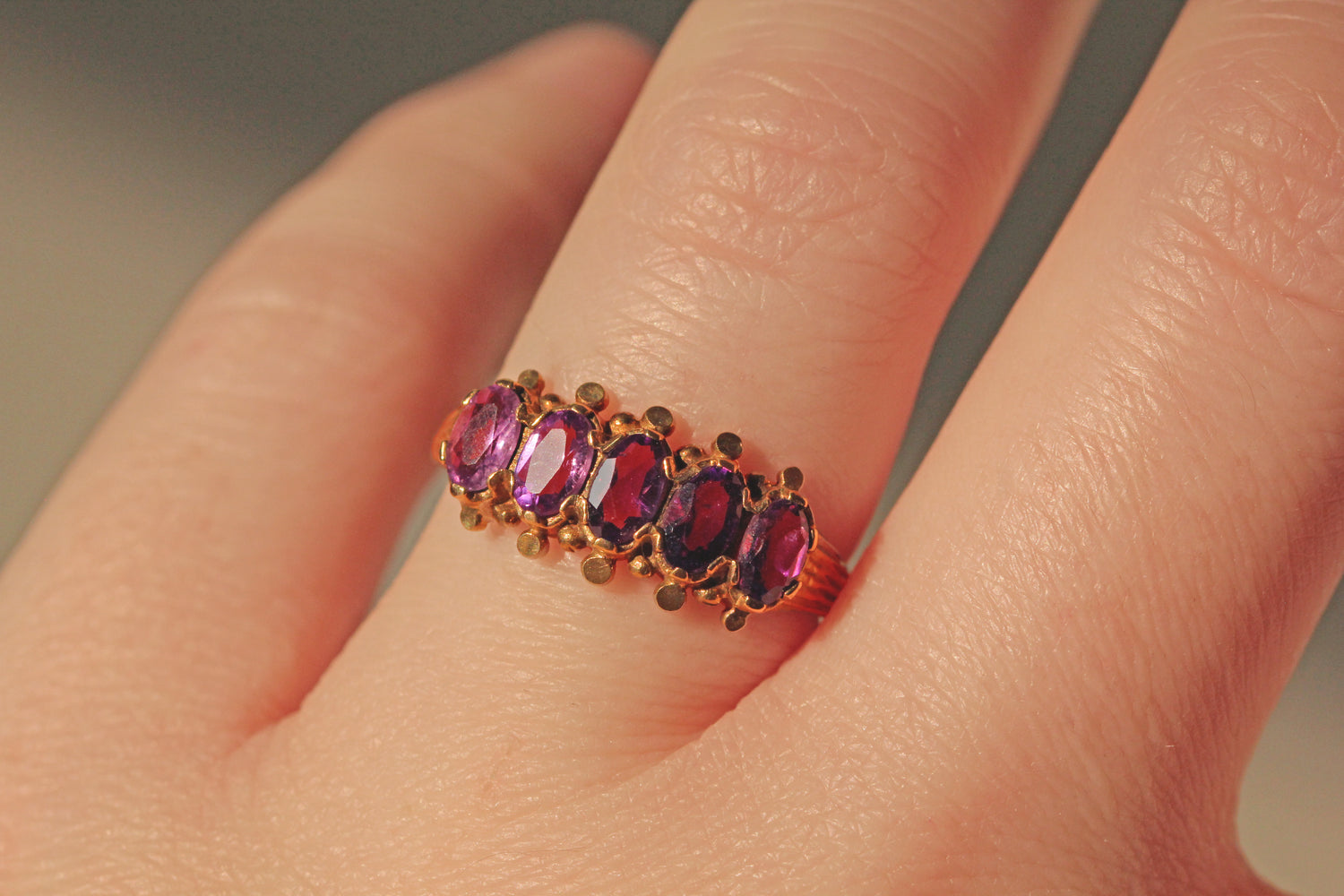 Vintage amethyst five stone ring in 9ct gold on finger 
