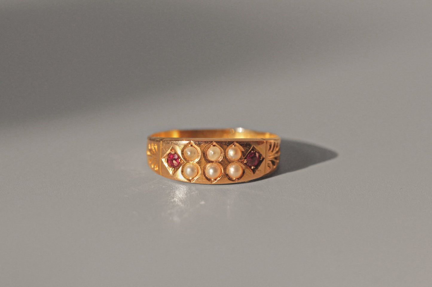 Antique victorian ruby & seed pearl band ring, in 15 carat gold