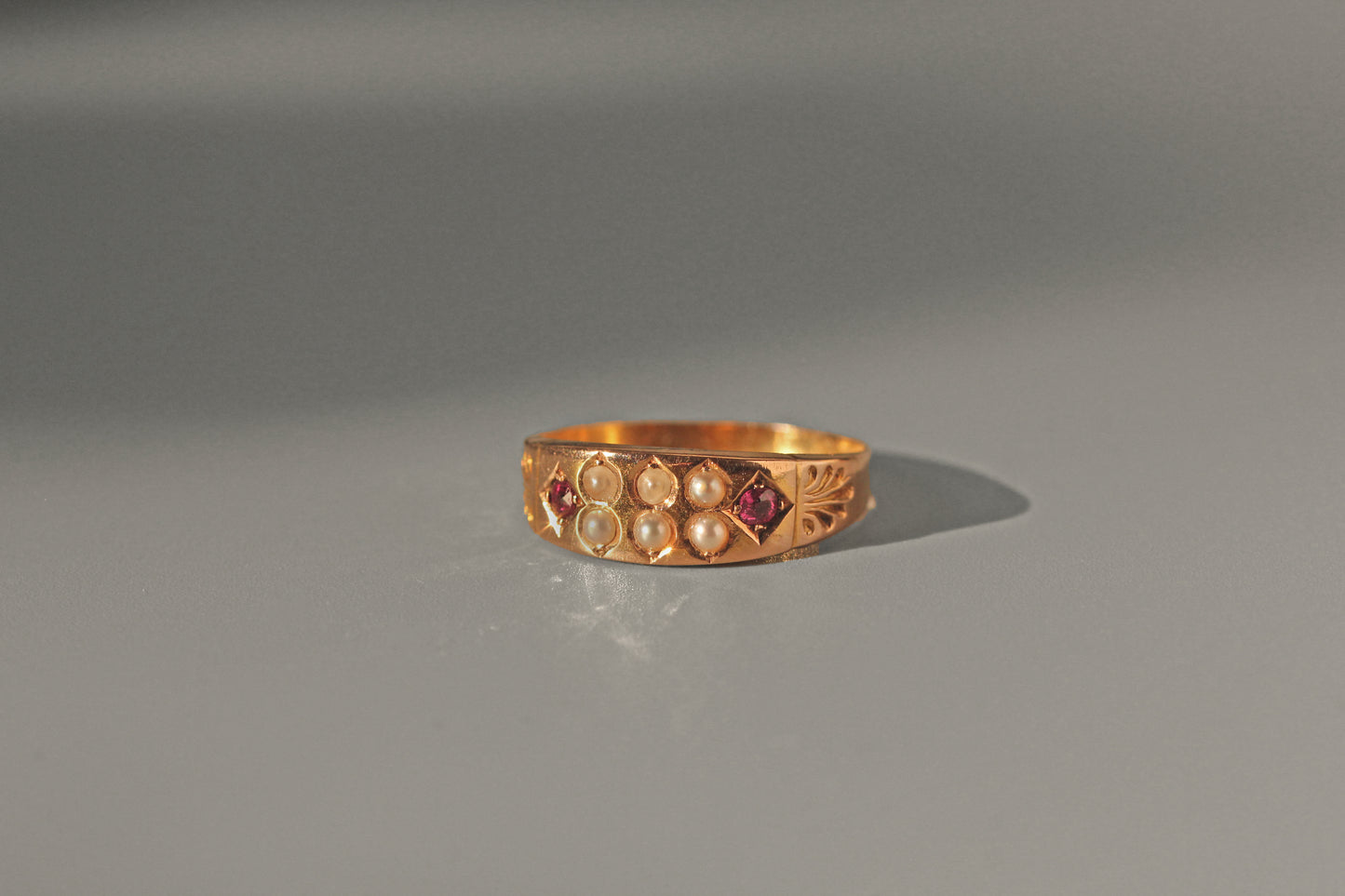 Antique Victorian ruby and seed pearl band ring in 15 carat gold
