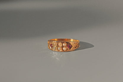 Antique Victorian ruby and seed pearl band ring in 15 carat gold
