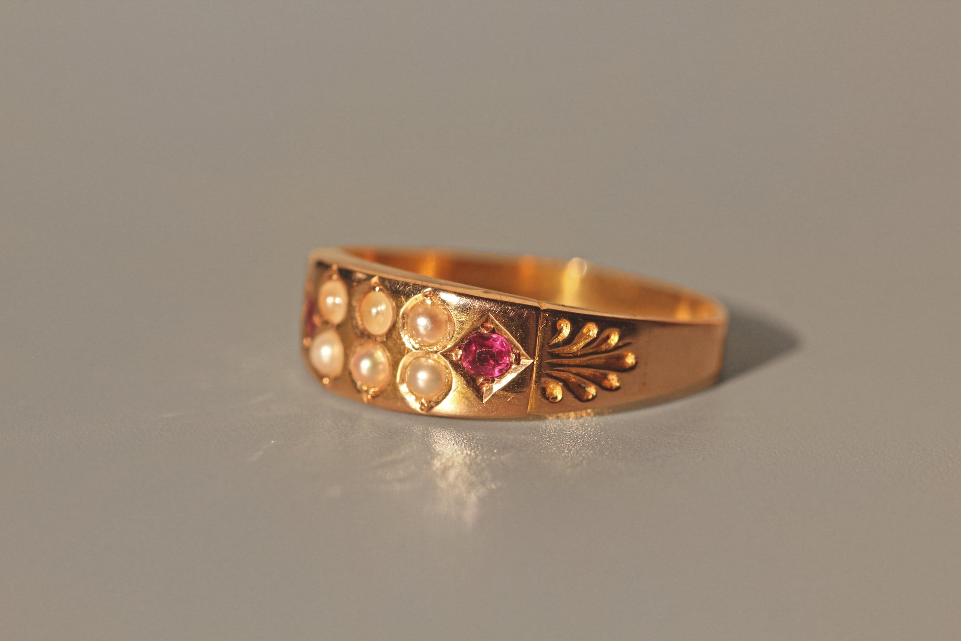 Side view of antique ruby and seed pearl band ring