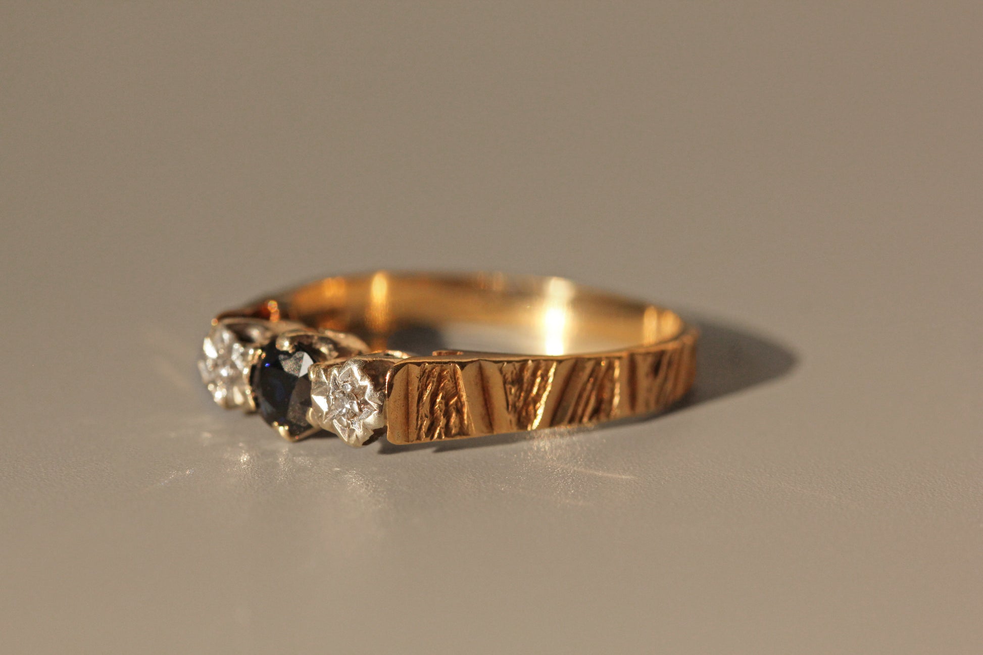 Side view of vintage sapphire and diamond trilogy ring