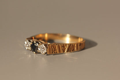 Side view of vintage sapphire and diamond trilogy ring