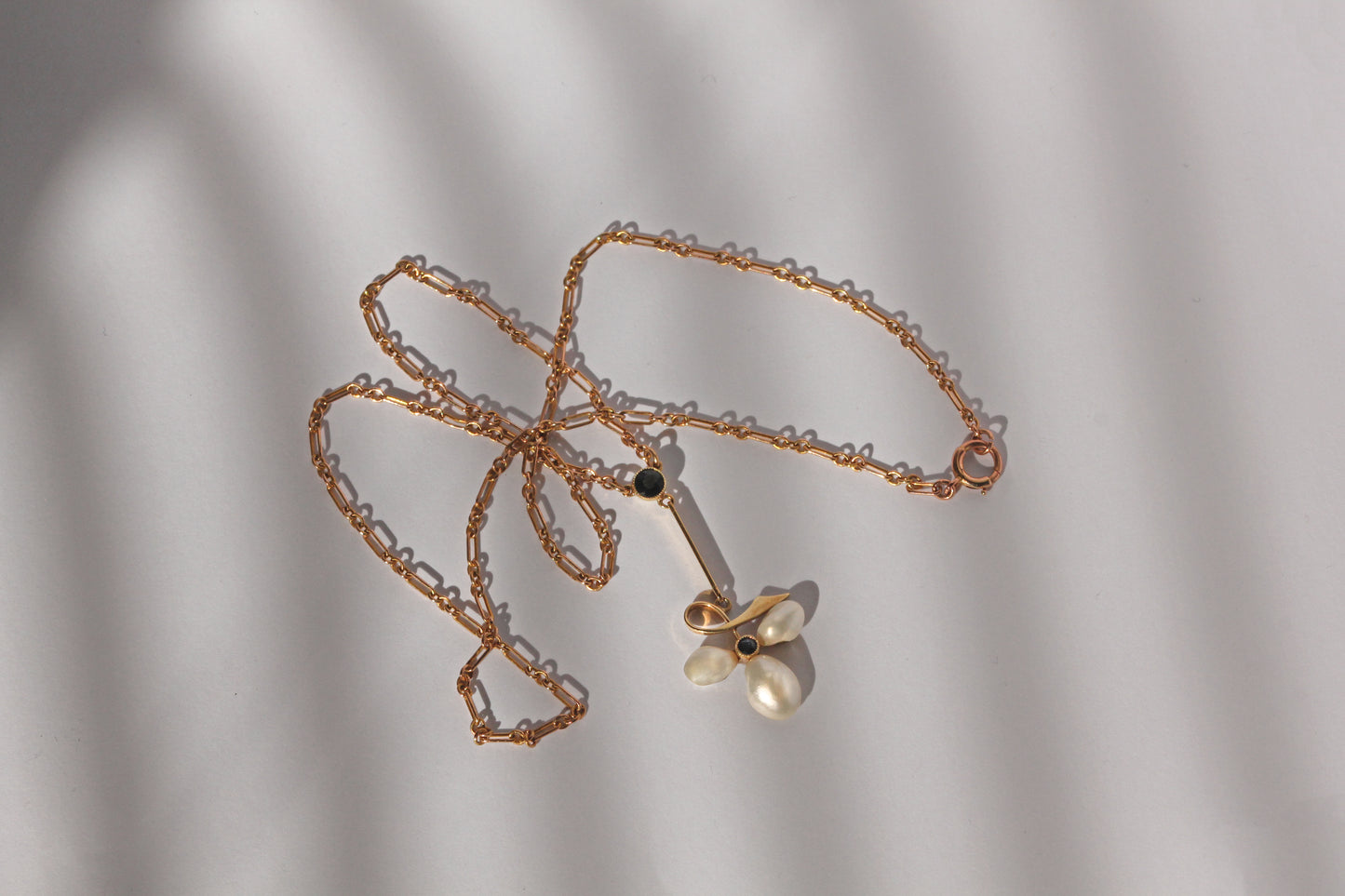 Edwardian 15ct gold necklace with baroque pearl leaf design and sapphire