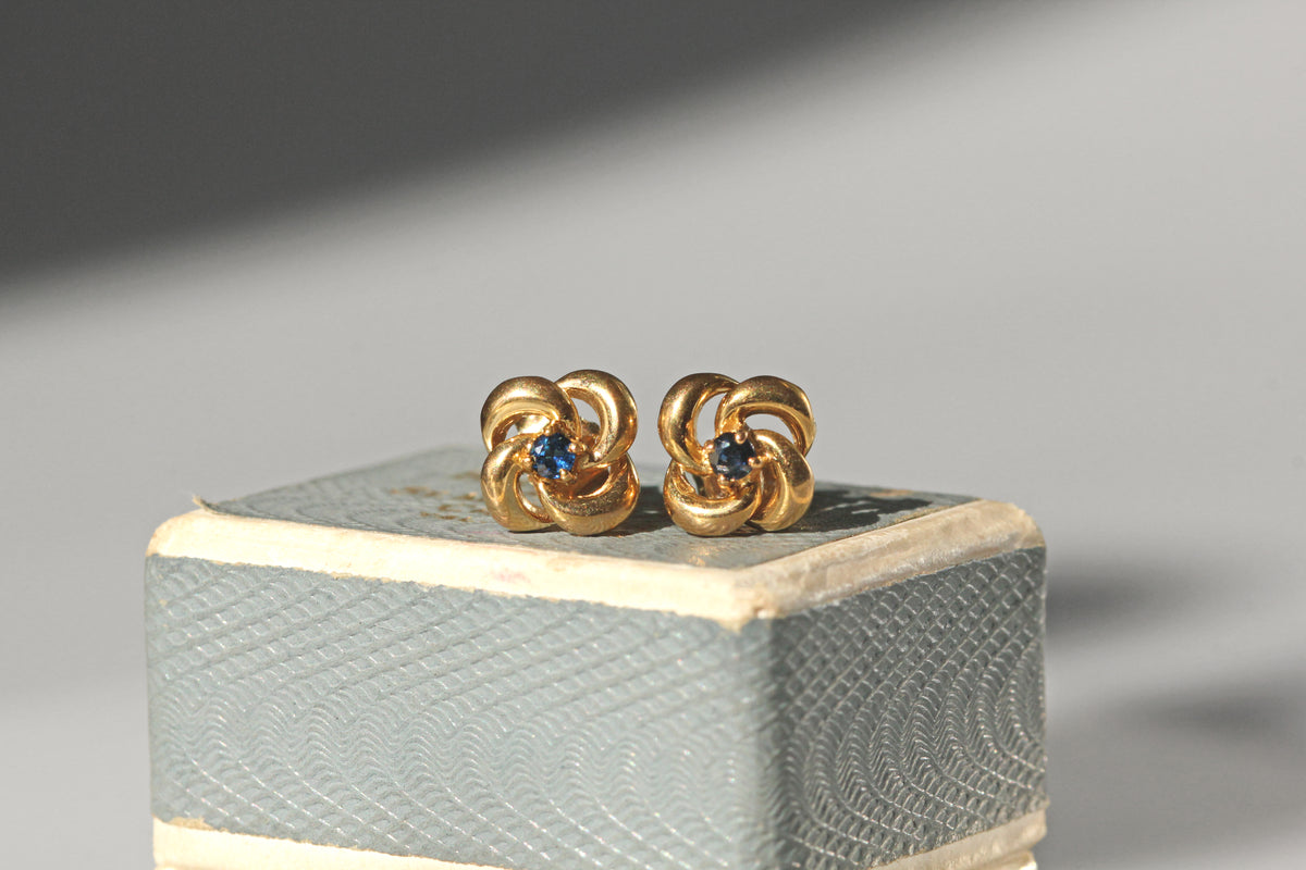 Vintage sapphire love knot stud earrings in 9 carat gold on vintage ring box