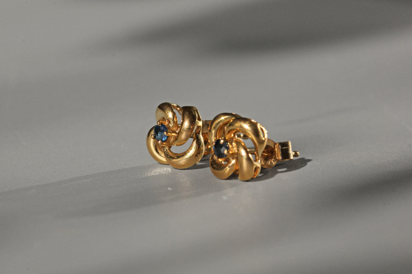 Vintage sapphire love knot stud earrings, in 9 carat gold