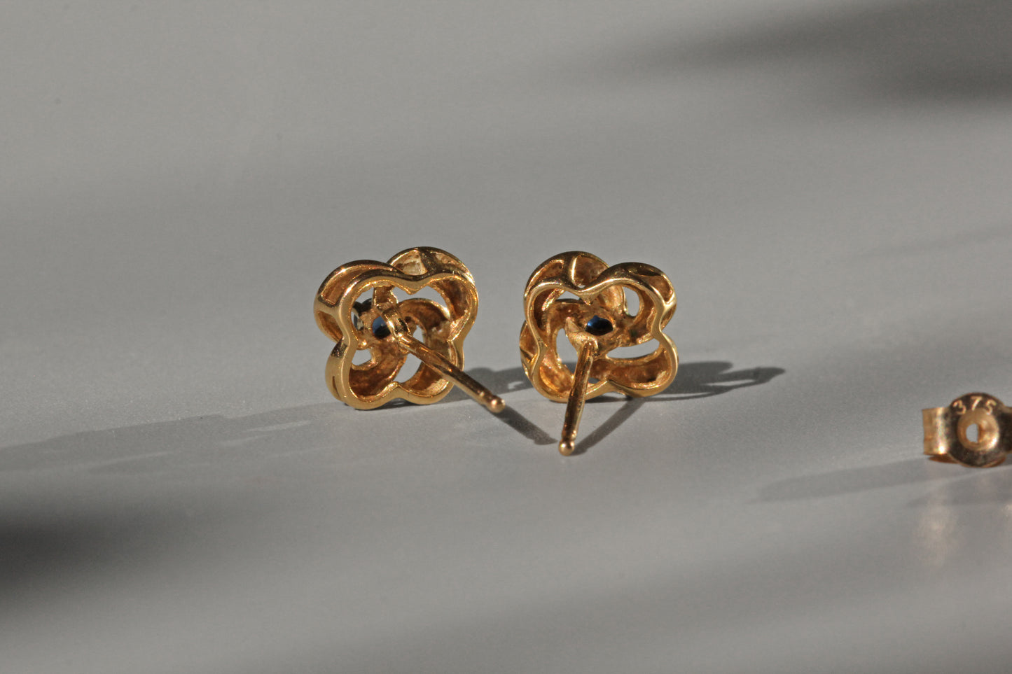 Vintage sapphire love knot stud earrings, in 9 carat gold