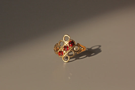 Vintage garnet trilogy openwork panel ring in 9ct gold in the sun