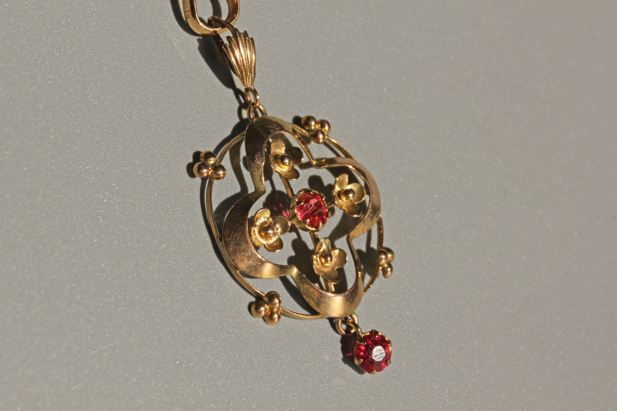 Antique gold lavaliere pendant with openwork and beaded detail
