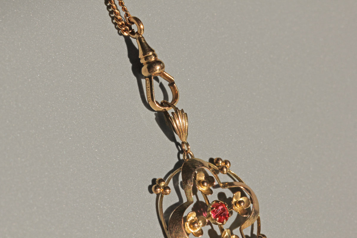 Edwardian ruby paste pendant with floral symbolism
