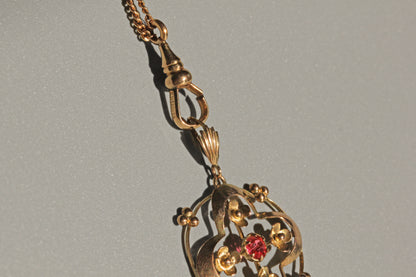Edwardian ruby paste pendant with floral symbolism
