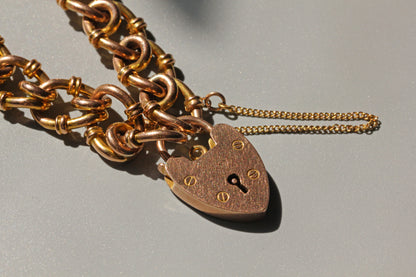 Close up of antique fancy link bracelet with rose and yellow gold tones
