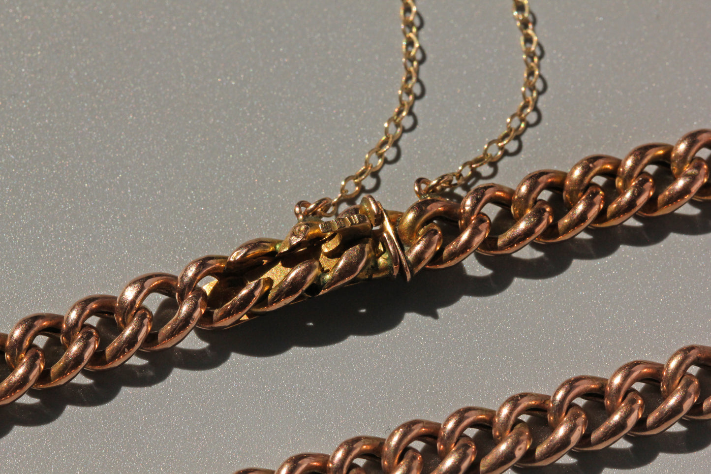 Antique concealed clasp bracelet with heavy curb links and polished gold finish
