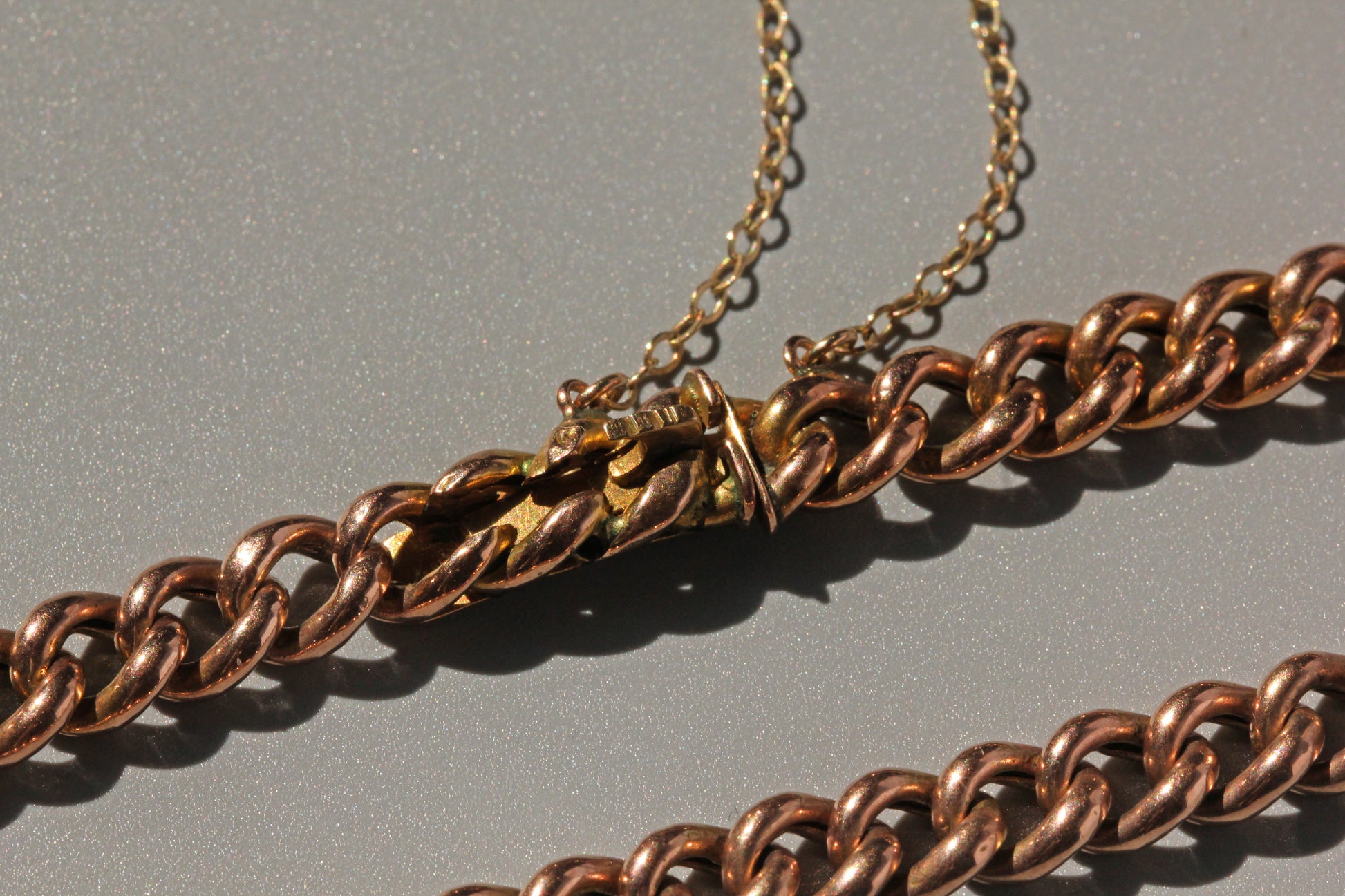 Antique concealed clasp bracelet with heavy curb links and polished gold finish
