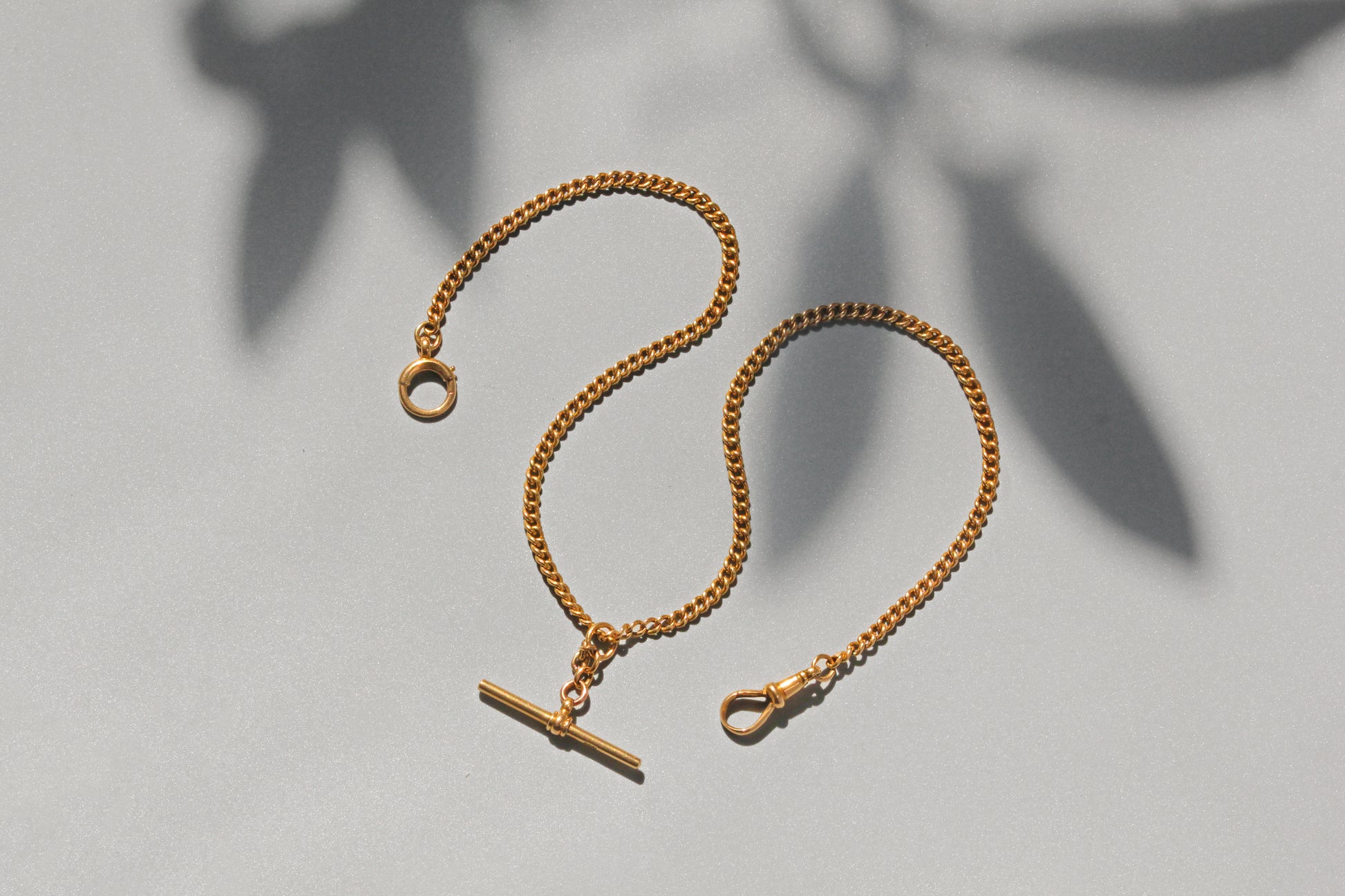 Close up antique gold Albert chain clasp detail
