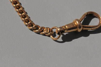 Antique curb link albert chain, in 18 carat gold