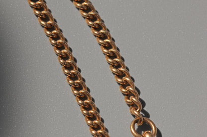 Antique curb link albert chain, in 18 carat gold