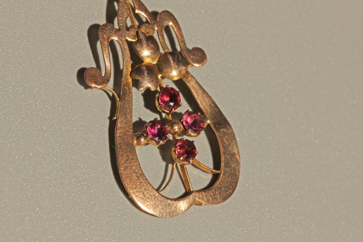 Antique ruby pendant with fleur de lis inspired silhouette
