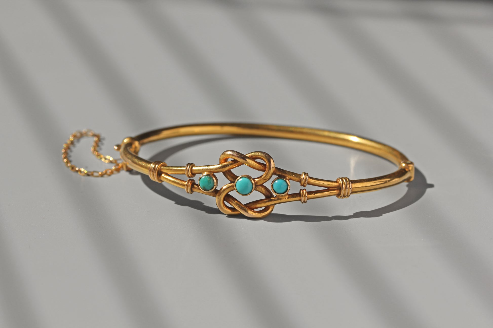 Antique turquoise and gold bangle with safety chain
