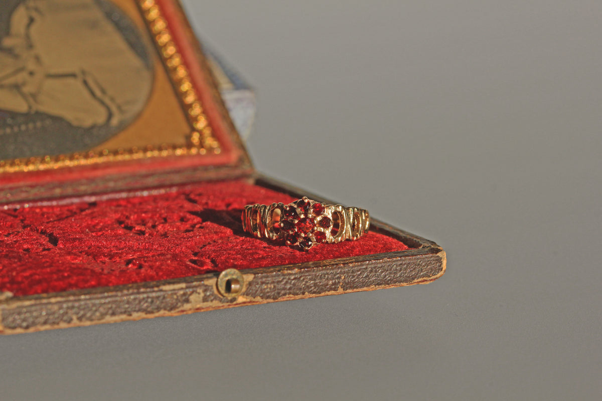 Vintage gold garnet ring with openwork shoulders
