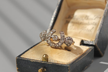 Antique diamond horseshoe ring with collet set centre diamond
