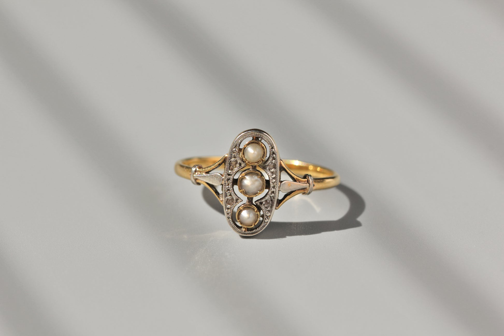 Antique pearl diamond ring with openwork detail
