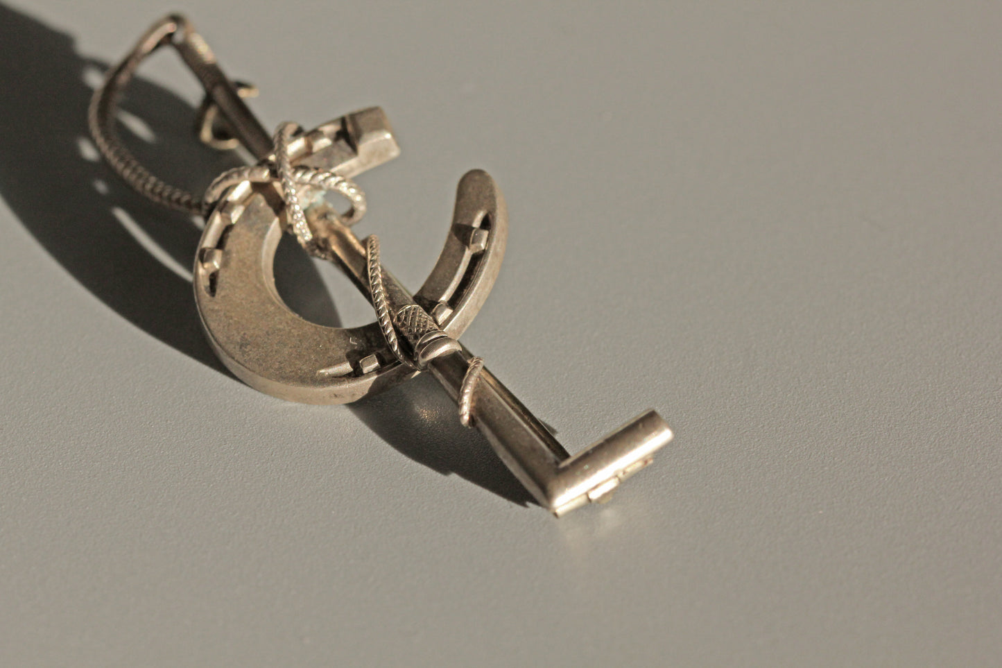 Antique lucky horseshoe riding crop brooch, in sterling silver