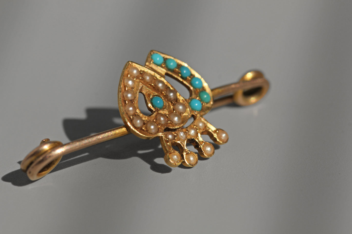 Victorian turquoise cabochon and seed pearl brooch with traditional crowned heart design
