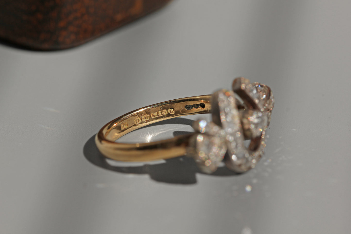 Side view antique diamond horseshoe ring in gold
