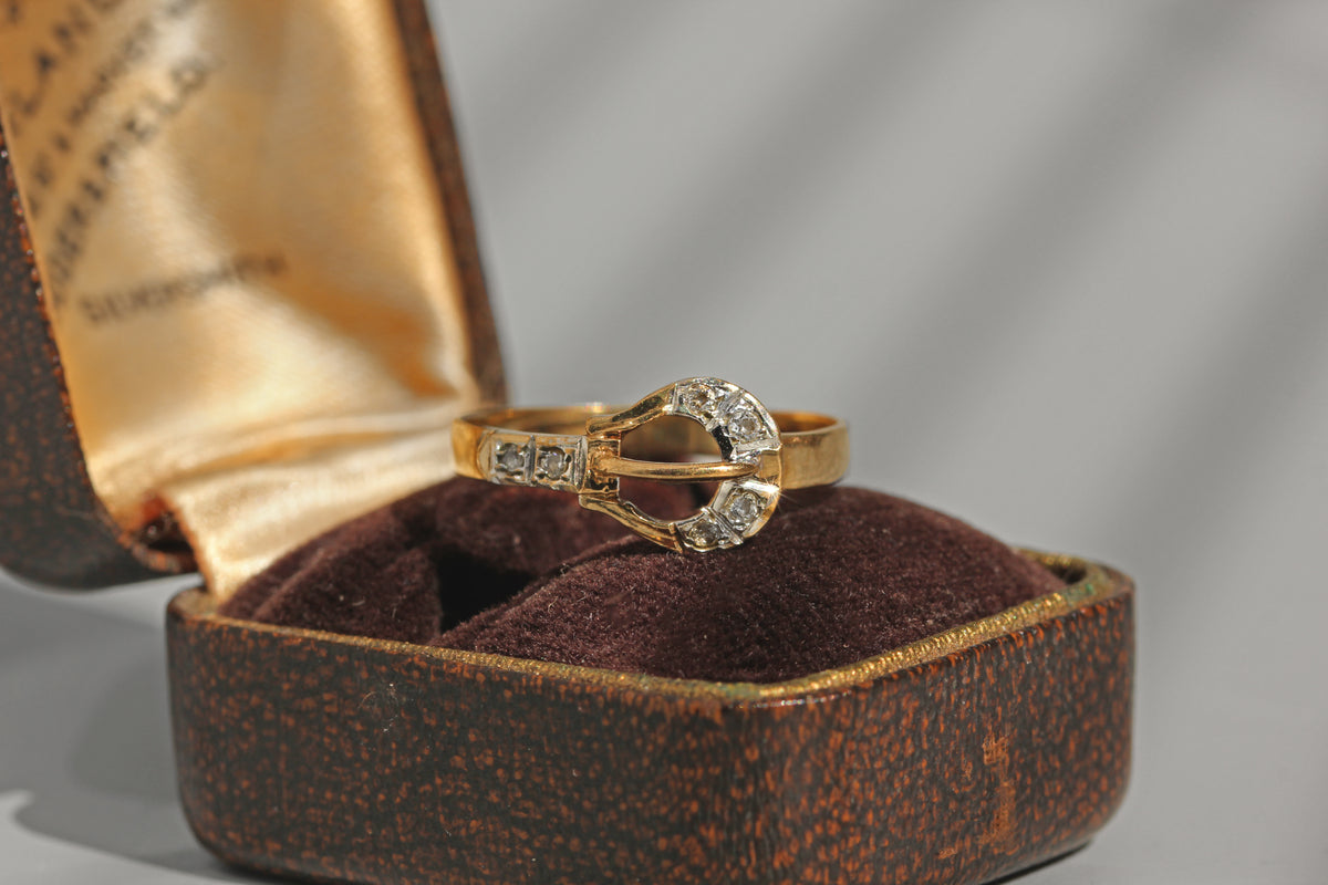 Vintage diamond belt buckle ring in 9 carat gold on ring box
