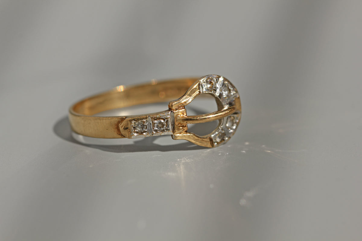 Gold belt buckle ring with diamond detail
